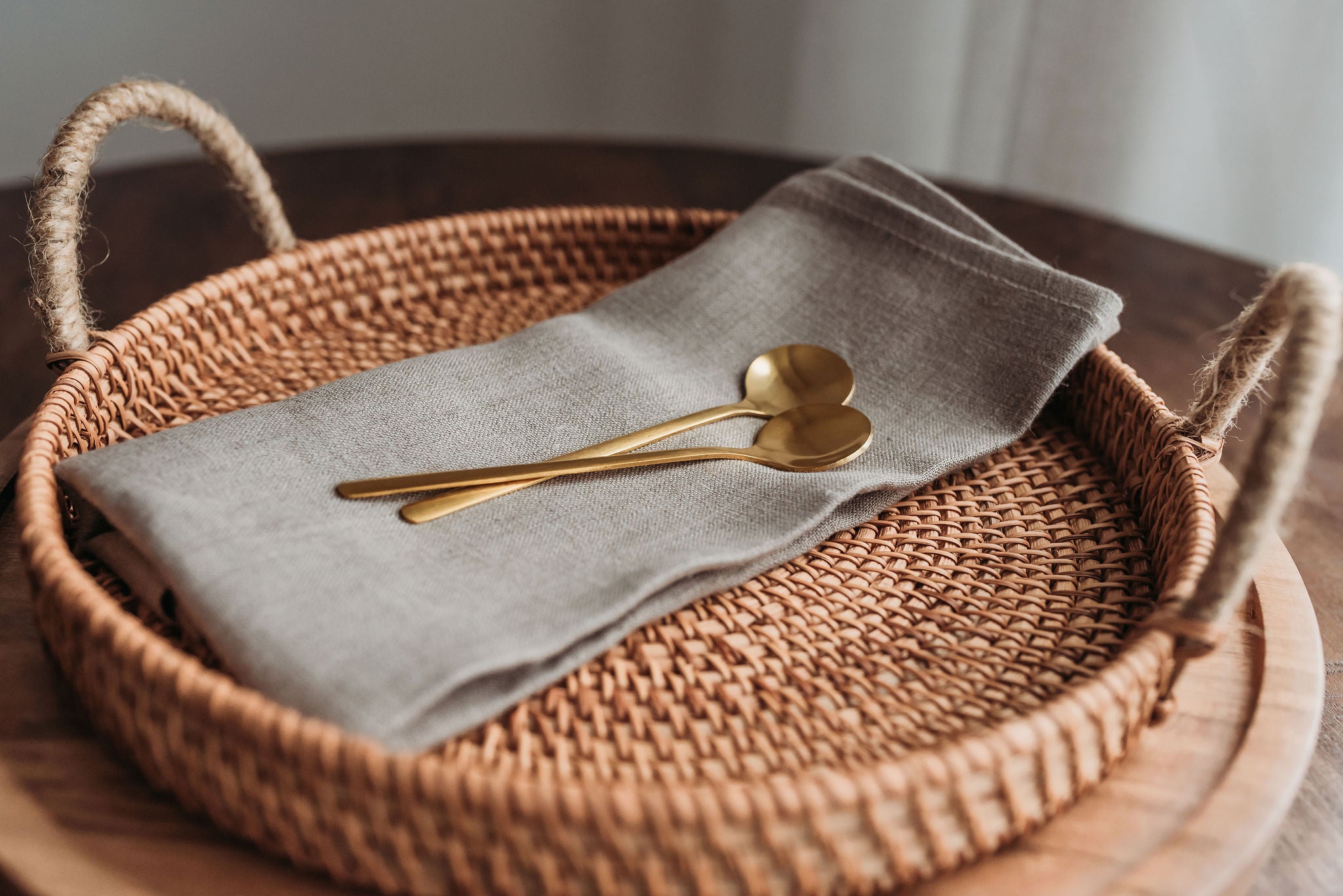 Woven rattan tray with linen and spoons