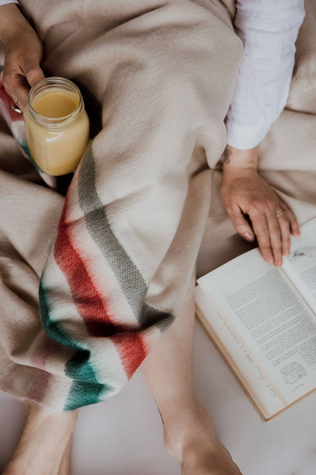 Brushed Alpaca Throw Blanket while reading a book.