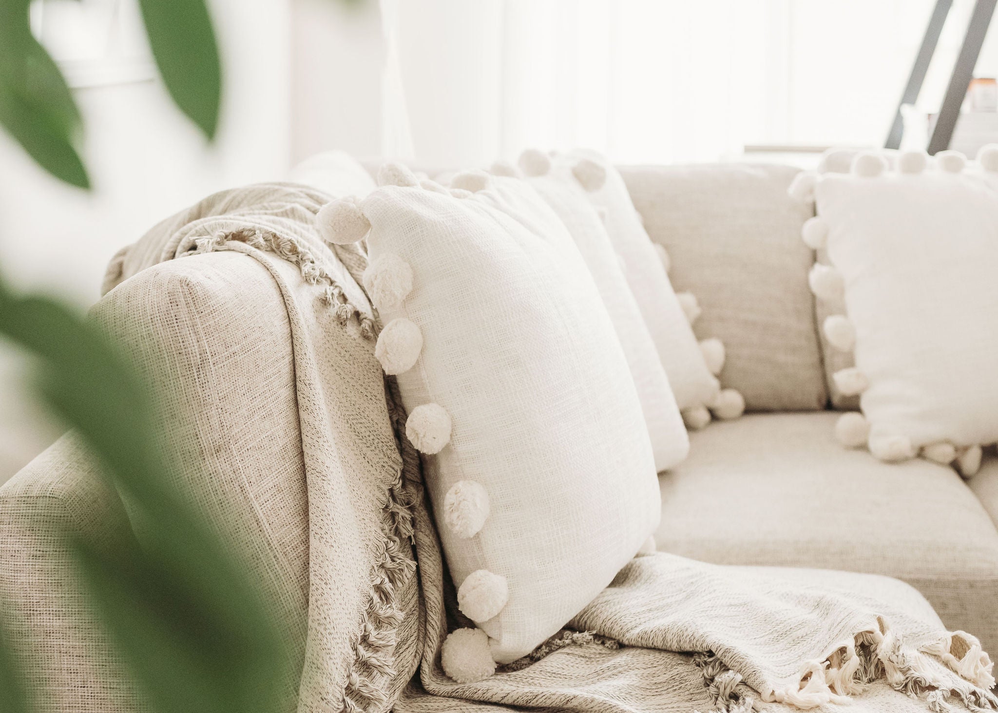 POM POM pillow on a couch